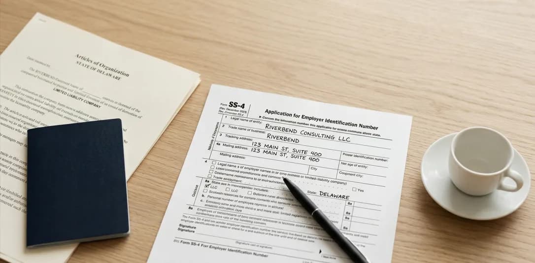 Form SS-4 application for an Employer Identification Number on a desk next to a US LLC formation certificate