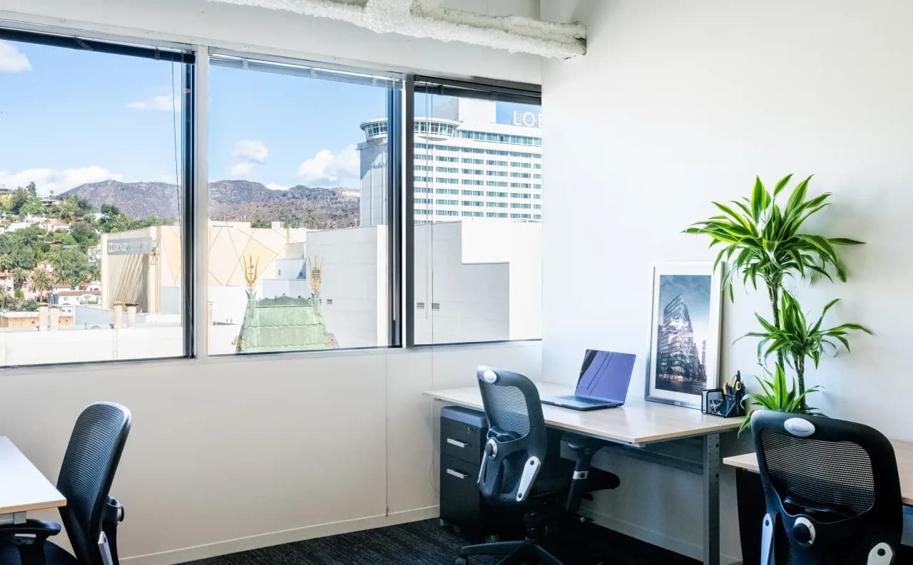 Private office with desks by a window overlooking the Hollywood hills, Los Angeles