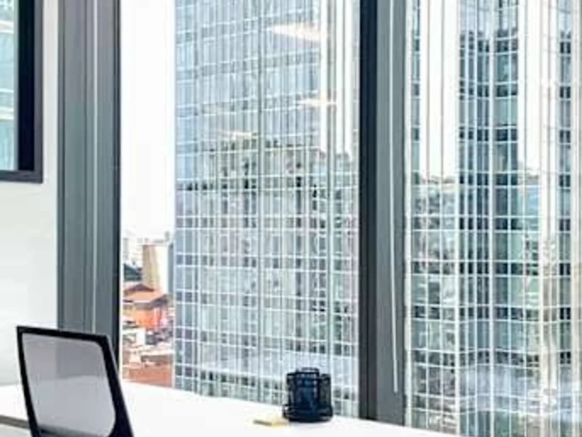 Desk by a floor-to-ceiling window overlooking downtown high-rises