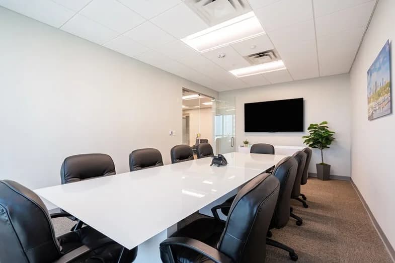 Meeting room with a conference table and wall-mounted screen, Tampa, Florida