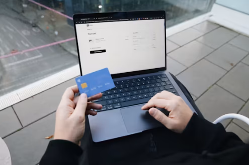 Laptop showing a business bank account application form with address fields highlighted