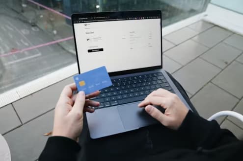 Laptop showing a business bank account application form with address fields highlighted