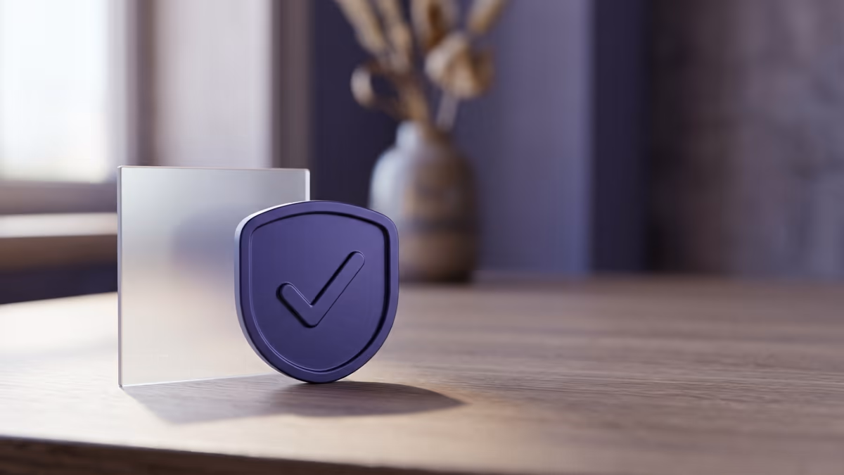 An abstract verification badge with a check mark beside a frosted glass panel, representing advertiser identity verification