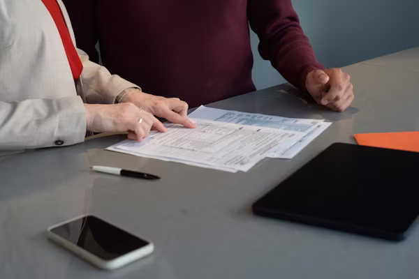 Professional signing LLC formation documents at a desk with legal paperwork