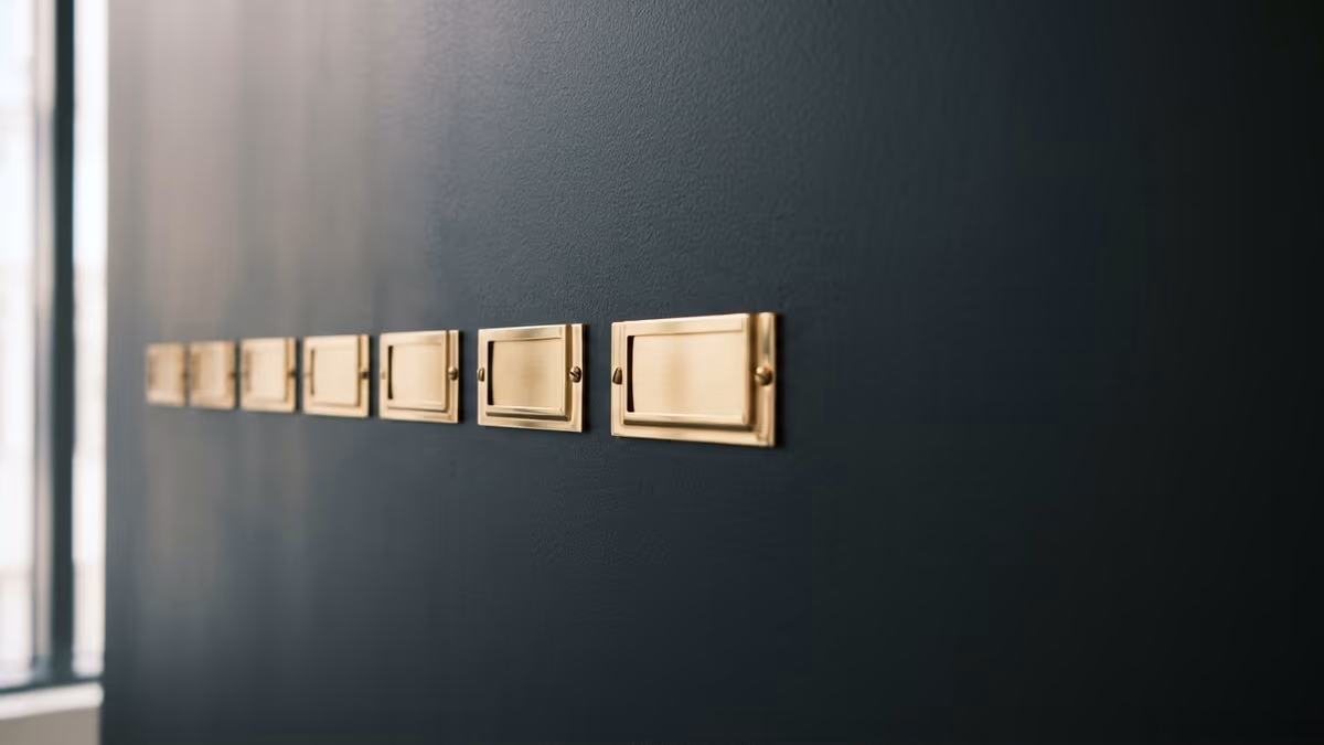 A row of labeled mail slots in an organized mailroom, representing several separate businesses sharing one professional address