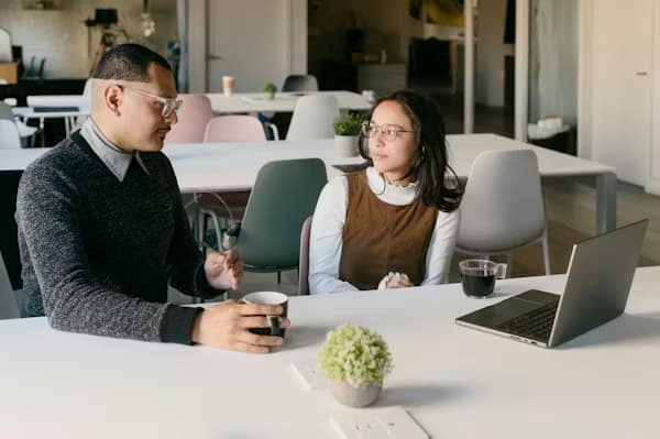 People collaborating in a shared coworking space with open floor plan