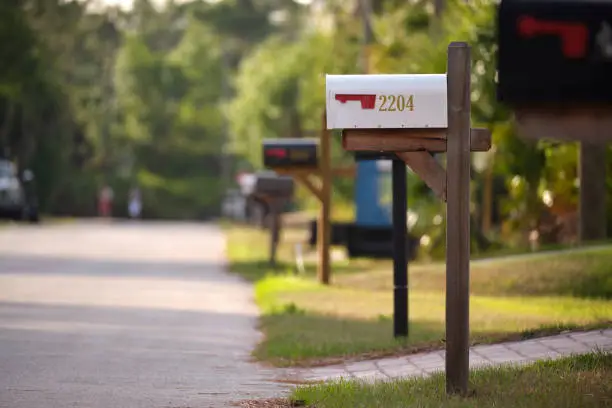 Residential mailboxes lined up along a street representing traditional mail delivery versus virtual office solutions